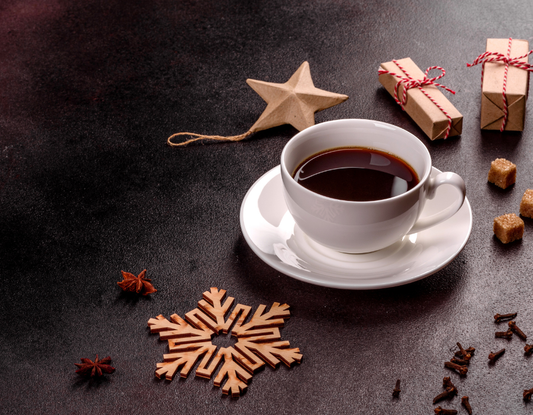 freshly brewed coffee surrounded by Christmas decorations